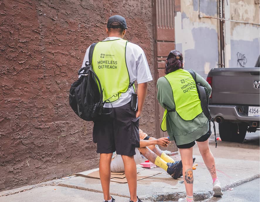 CCD outreach workers wearing a bright vest with Homeless Outreach written on the back.