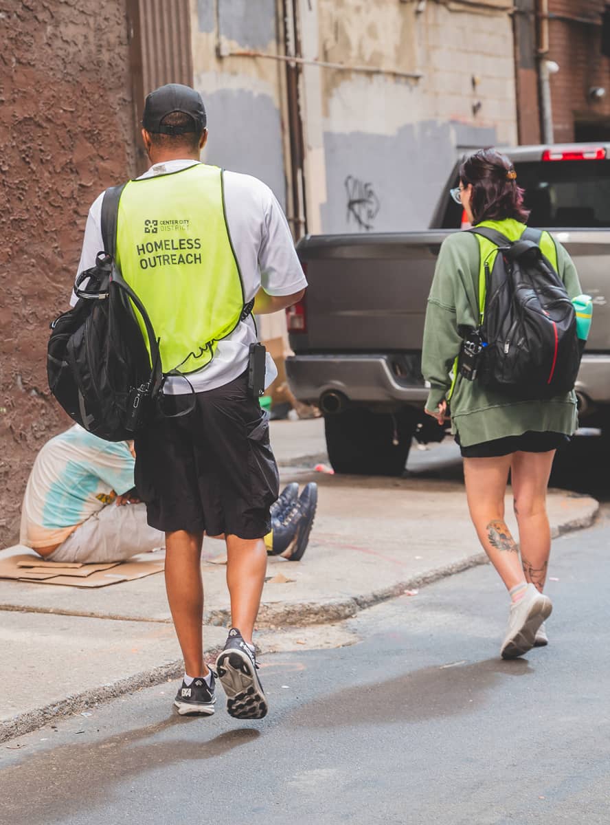 CCD outreach workers wearing a bright vest with Homeless Outreach written on the back.