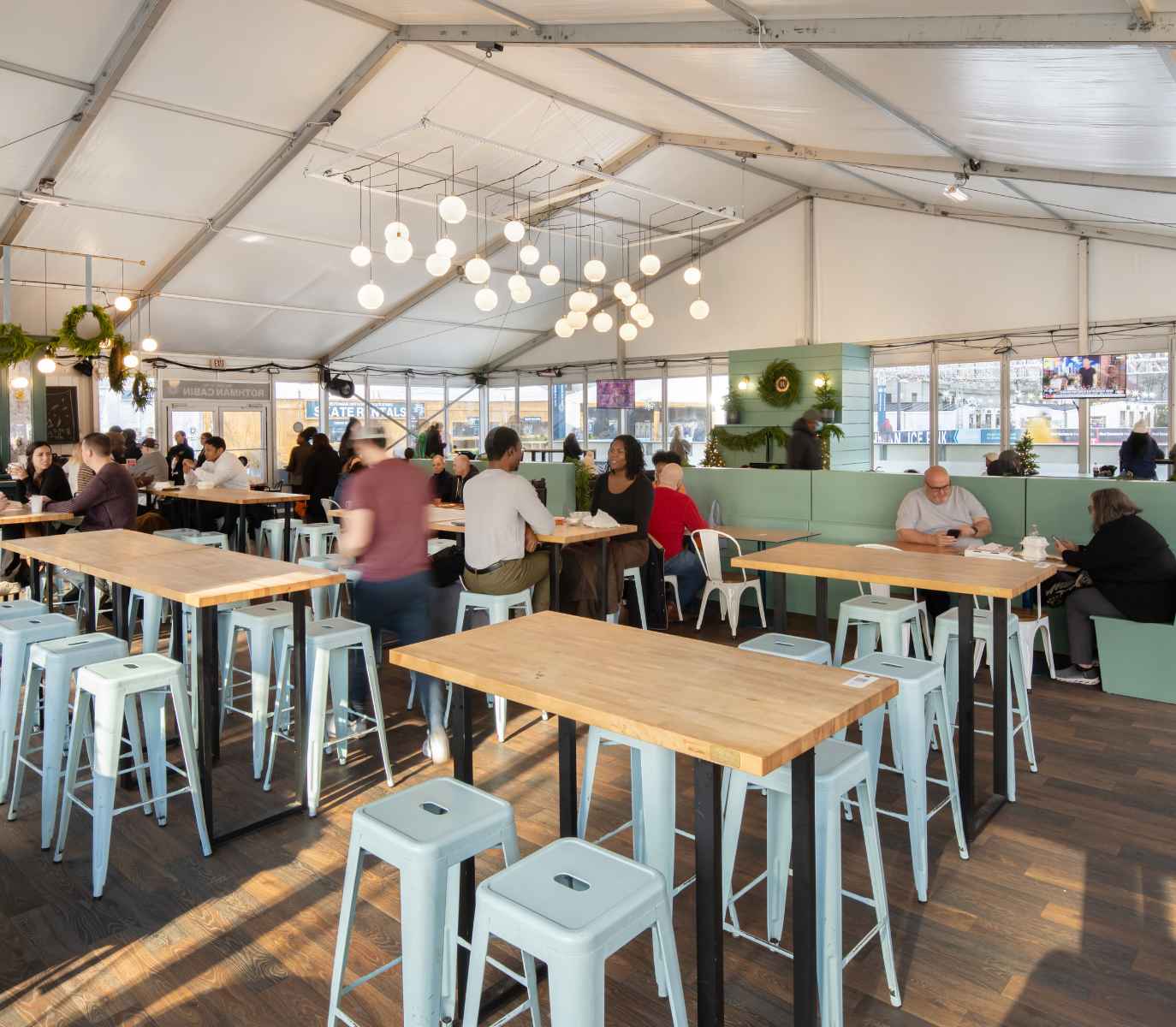 Interior shot of Rothman Orthopaedics Cabin with people dining at tables.